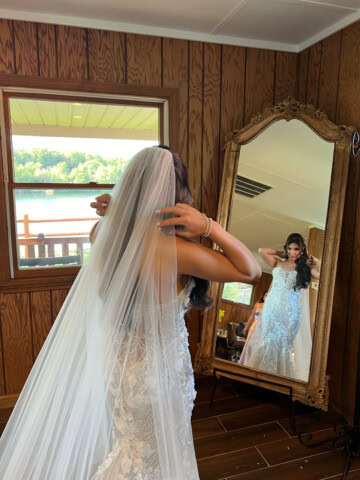 Bride getting ready in front of the full-size mirror