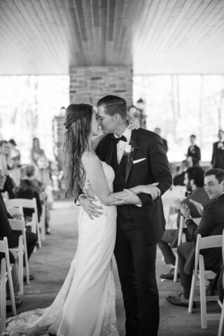 Couple kissing in the pavilion, black and white photography.