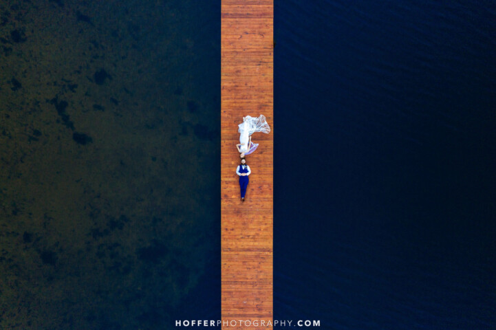 Couple laying on the dock, birds-eye view.