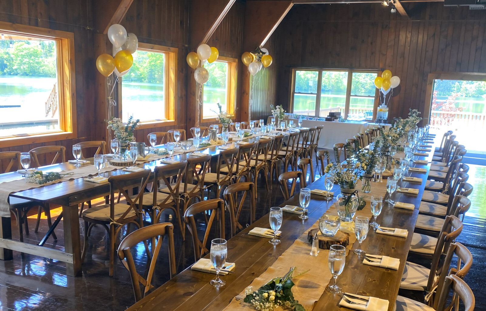 Boathouse set up for special event with tables in a row.