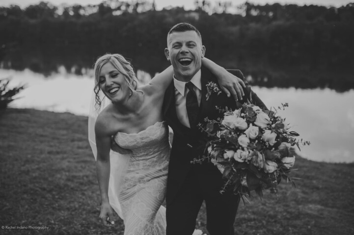Bride and groom enjoying a laugh, black and white photography.