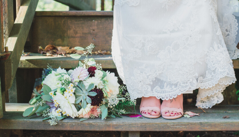 Wedding shoes on rustic step.