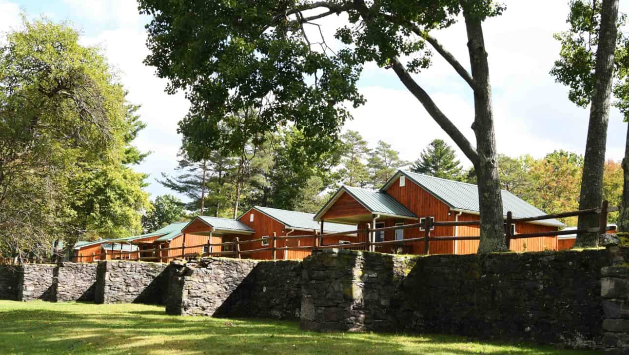cabins above a rock wall.
