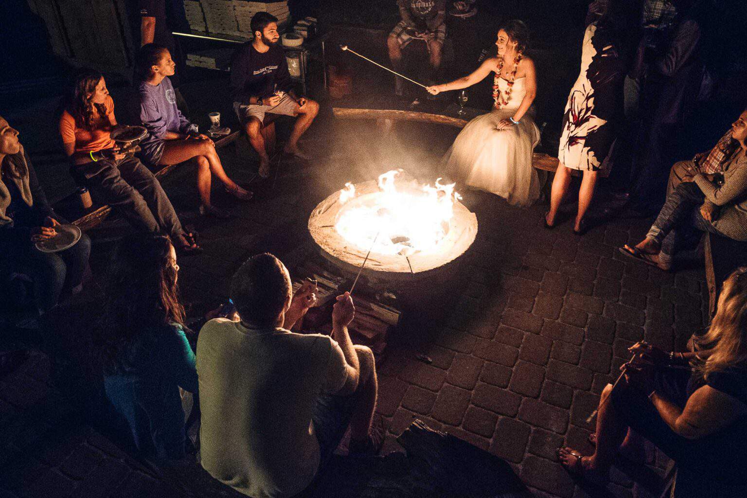 bride with a group around a campfire.