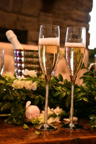 filled champagne flutes on a decorated table.