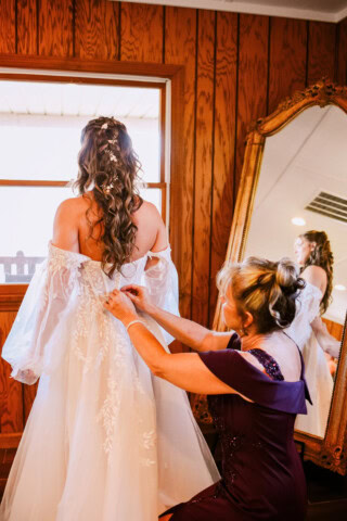 Making final djustments to bride dress.