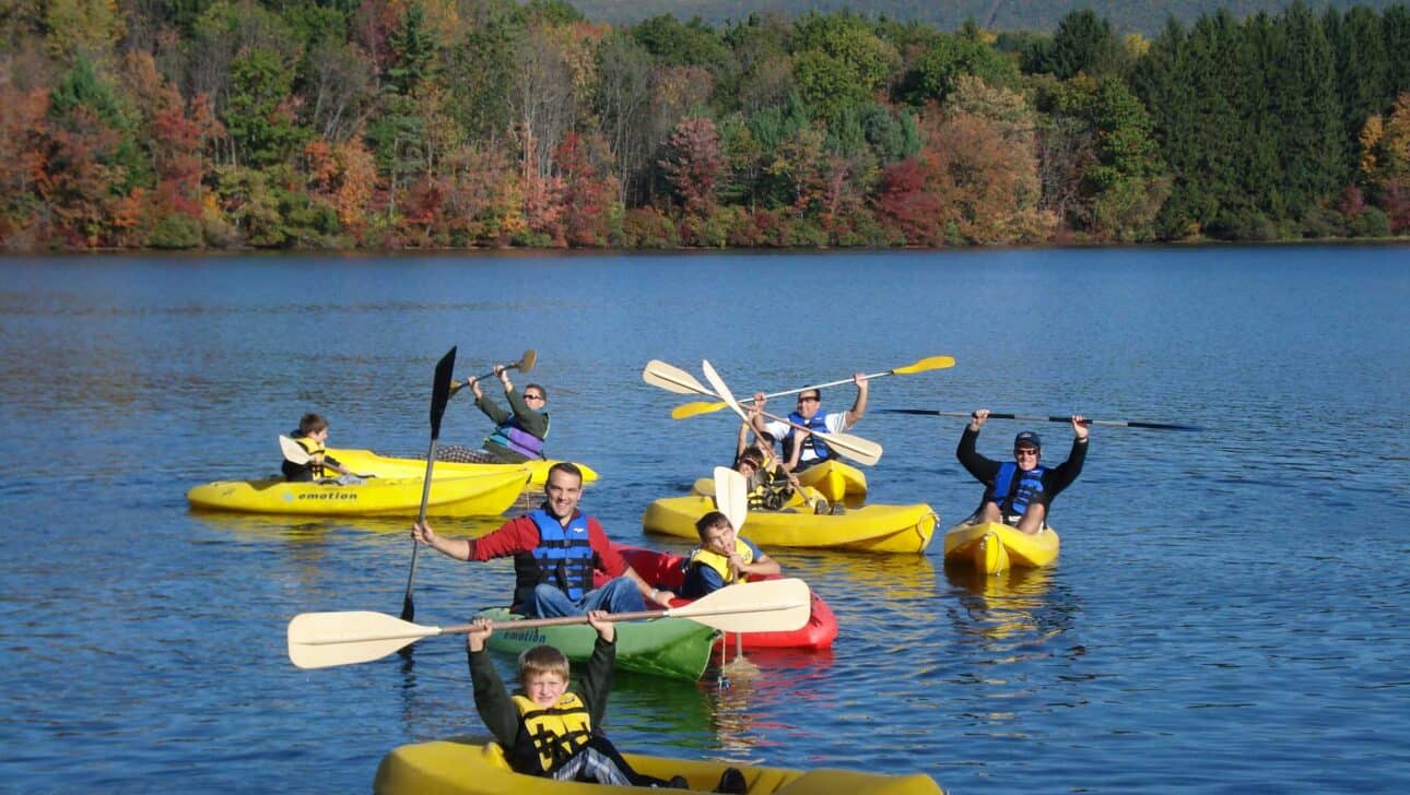 kayakers celebrating on a lake.
