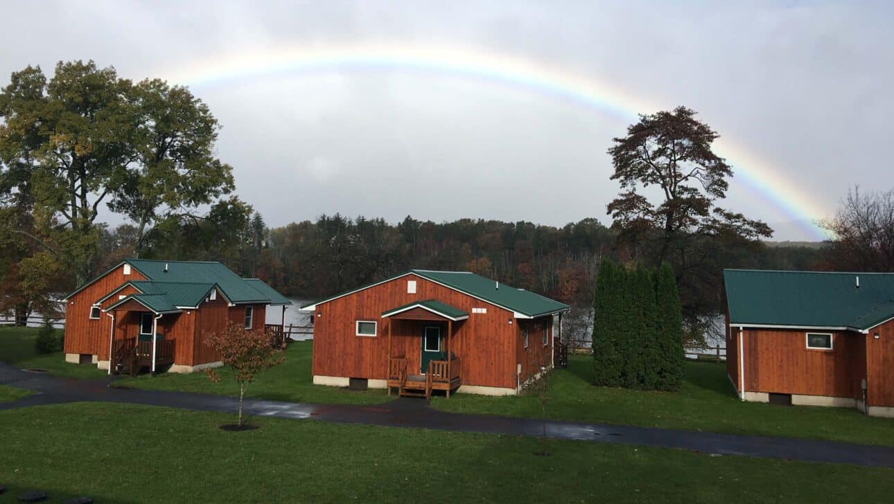 cabins underneath a rainbow.