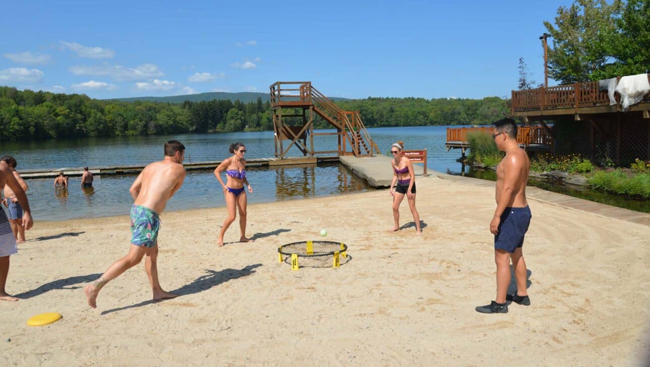 four people playing spikeball.