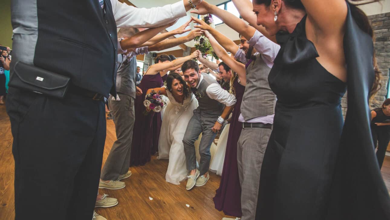 wedding couple running through a tunnel of arms.