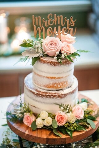 wedding cake with a sign that says mr and mrs moyer.