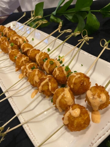 fried ball appetizers on skewers.