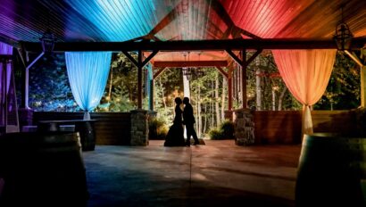 Silhouette of couple between bright red and blue lights.
