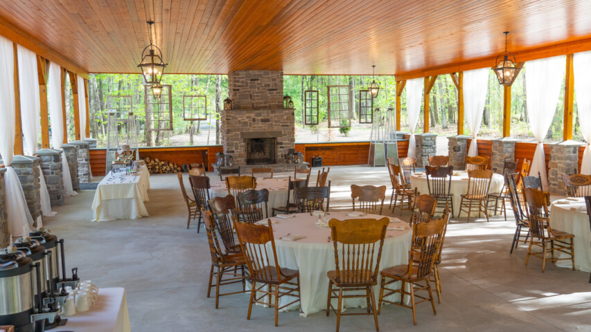 Woodland pavilion set up for event dining.