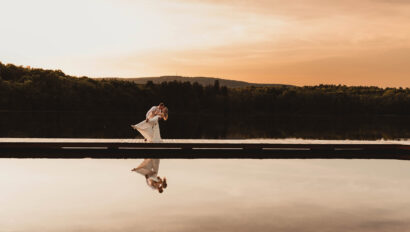 Bride & Groom on dock at sunset.