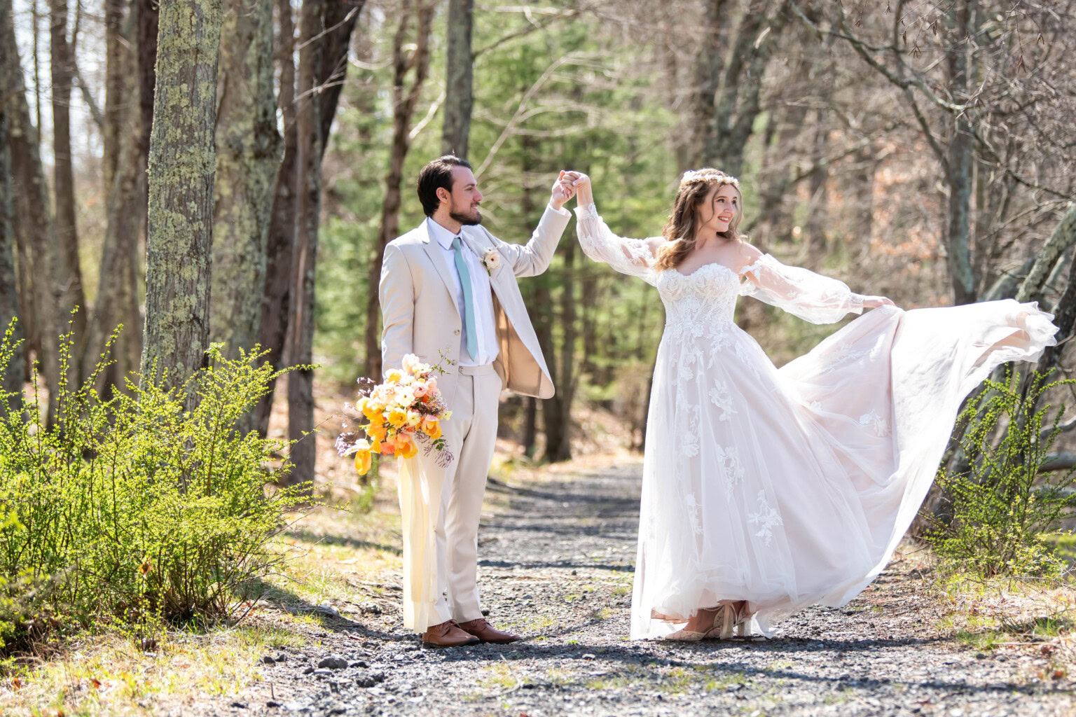 Bride and groom on lakeside gravel pathway