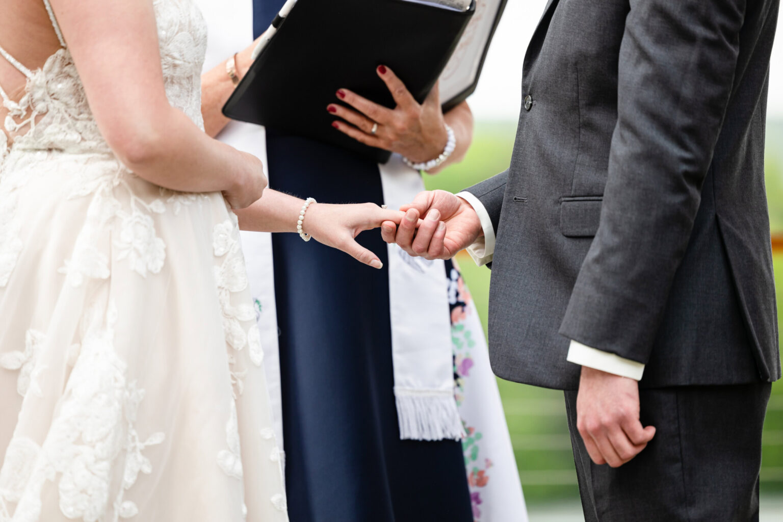 Couple holding hands during ceremony.