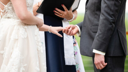 Couple holding hands during ceremony.