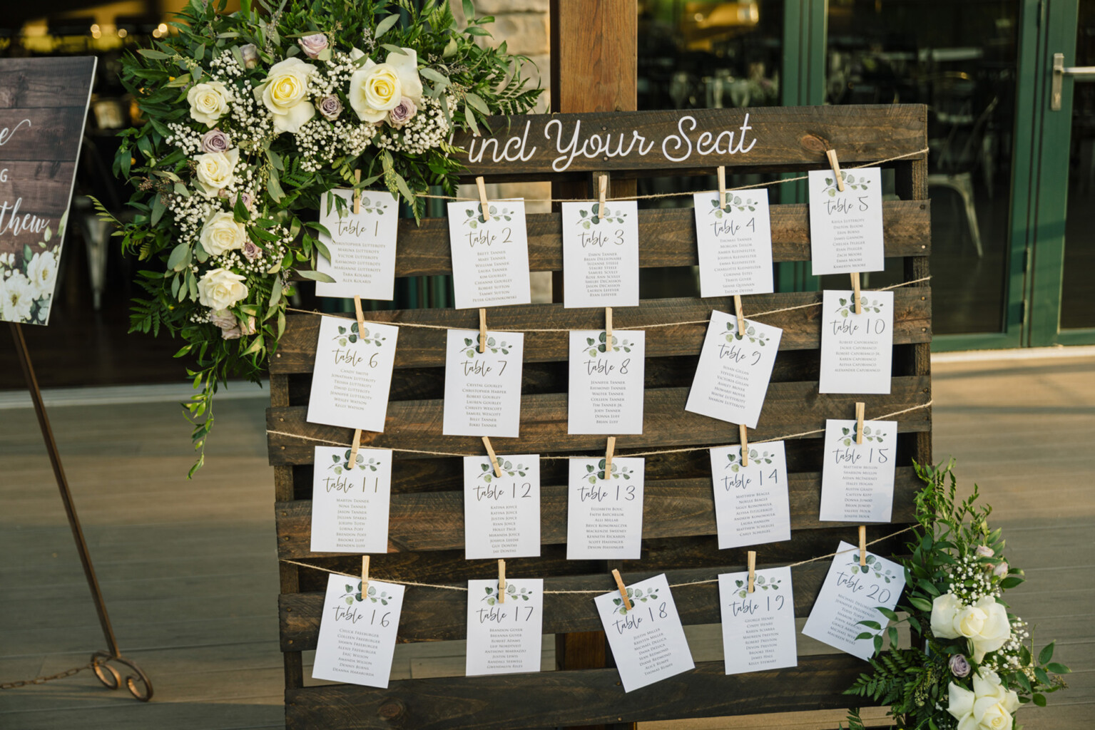 Table seating chart on wooden slat wall