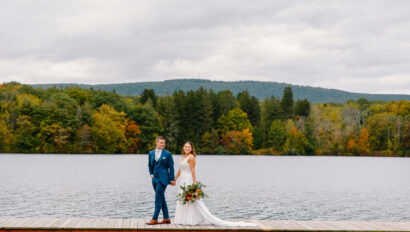 Fall foliage as couple walk on dock