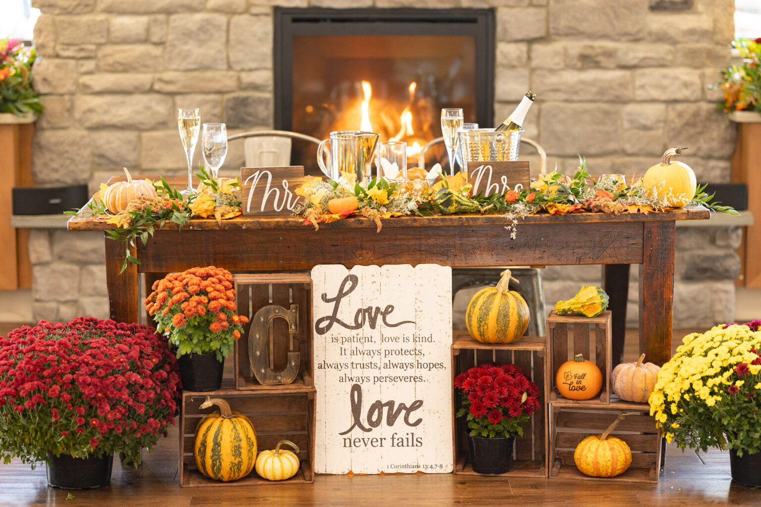 Sweetheart table with champagne and fireplace on