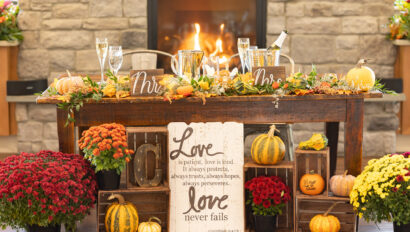Sweetheart table with champagne and fireplace on