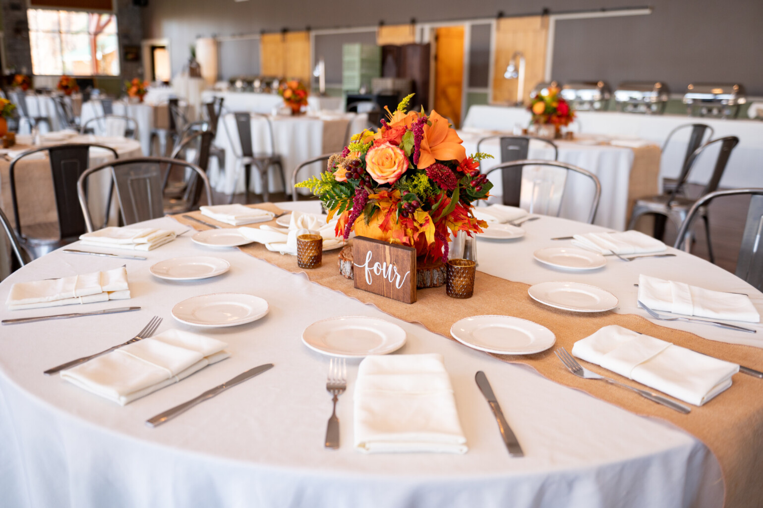 Fall centerpiece on burlap runner