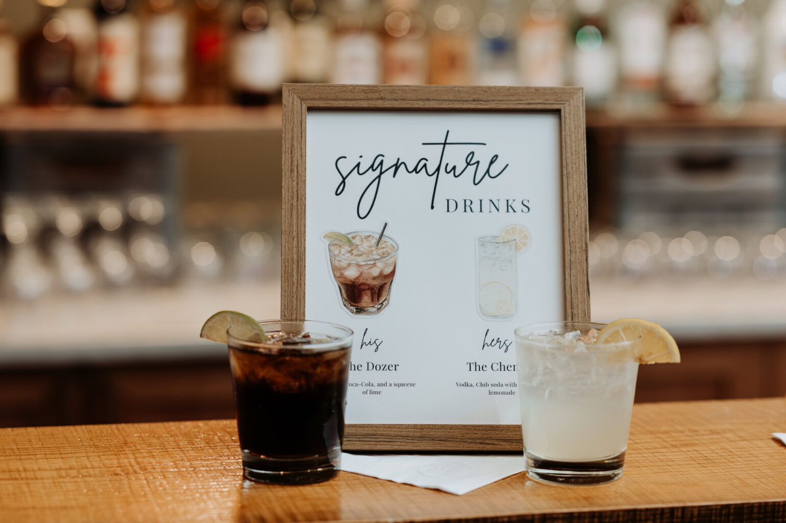 Signature drinks sign and drinks sitting on top of the bar.