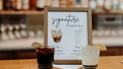 Signature drinks sign and drinks sitting on top of the bar.