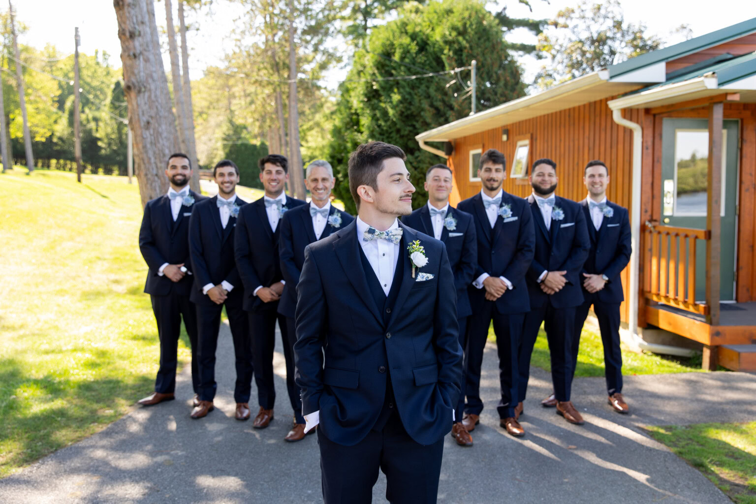 Groom and groomsmen outside getting ready cabin.