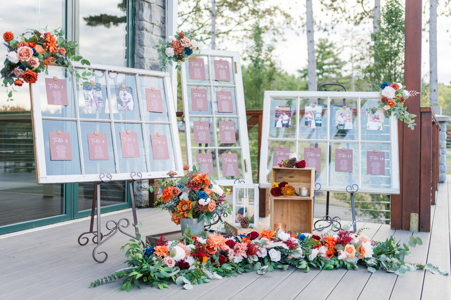 Seating chart in rustic windows surrounded by florals