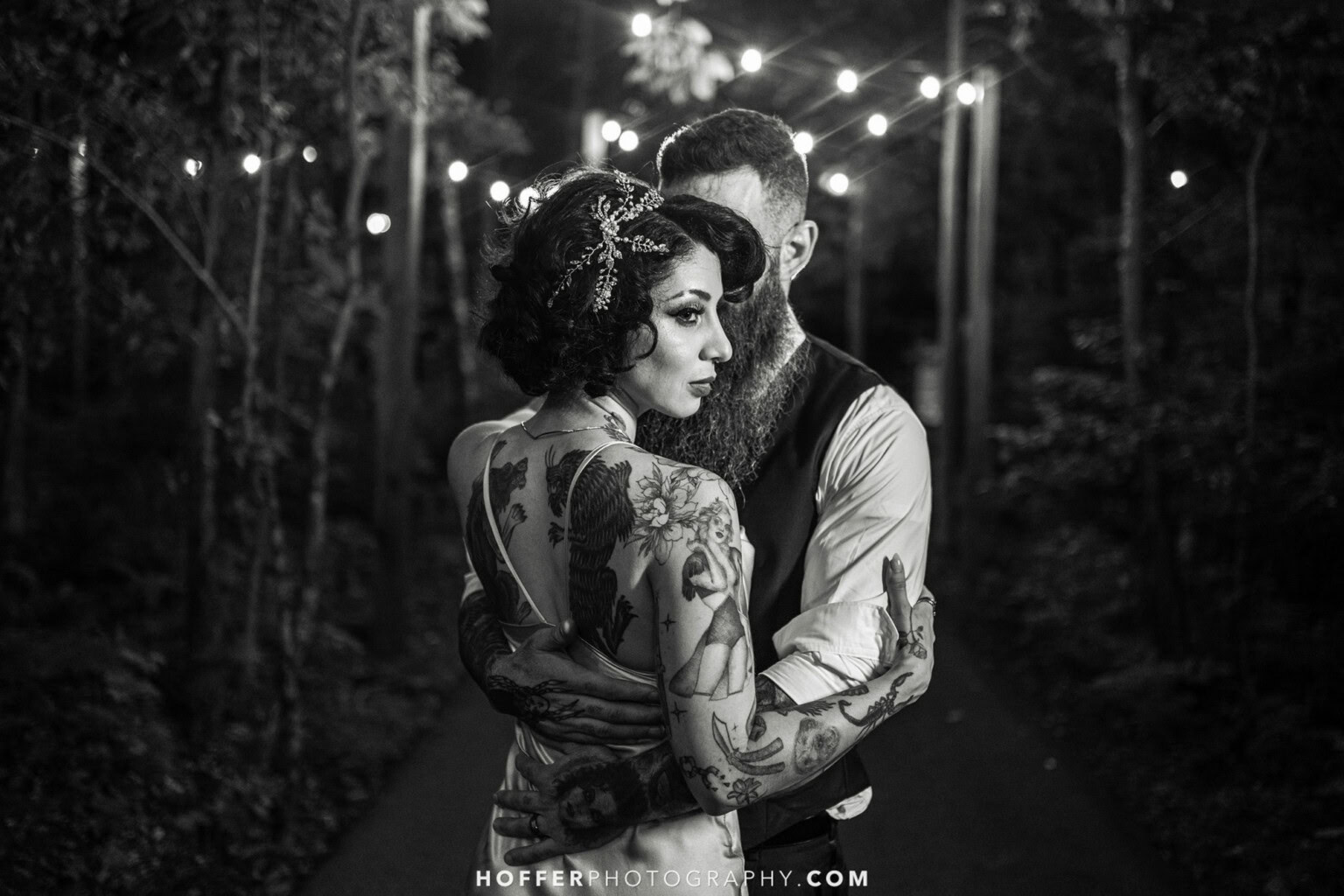 Black and white photo of couple embracing under the market light walkway